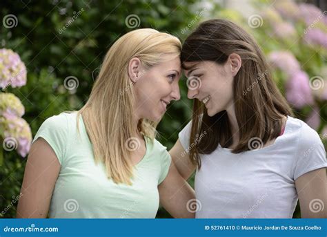 Lesbian Couple In Bedroom At Home Lying Hair Down Looking At Each Other Smiling Close Up Royalty