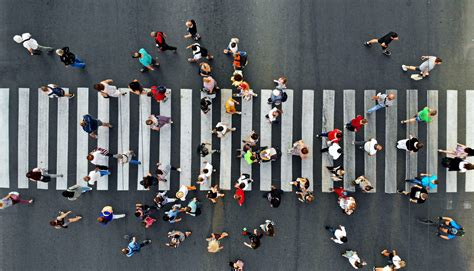 Aerial. People crowd motion through the pedestrian crosswalk. Top view from drone. - Edgewood ...