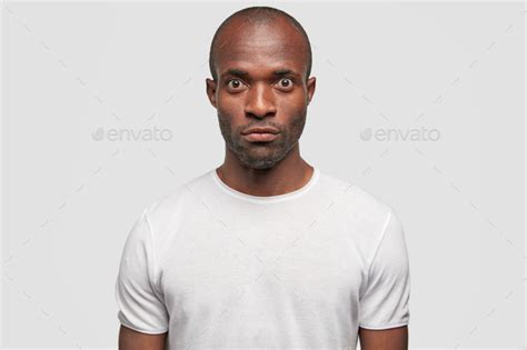 Photo Of Serious Dark Skinned Male With Surprised Expression Feels