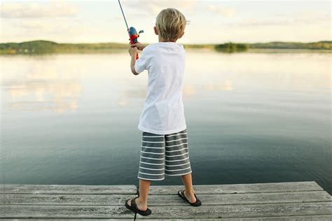 Young Child Fishing From A Pier By Stocksy Contributor Kelly Knox