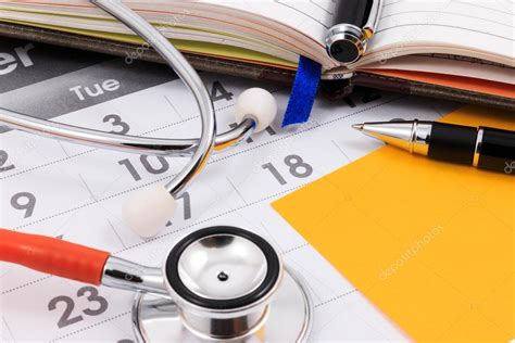 Close Up Of Stethoscope Pen And Paper Note On Calendar Doctor Appointment Stock Photo