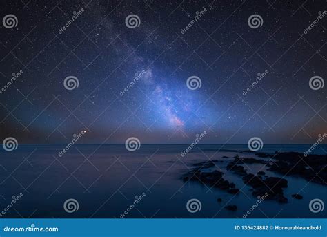 Vibrant Milky Way Composite Image Over Landscape Of Rocky Coastline In
