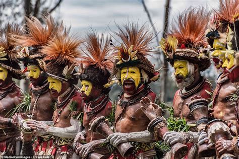 Papua New Guinea Tribesmen Cover Their Faces In Colourful Dye