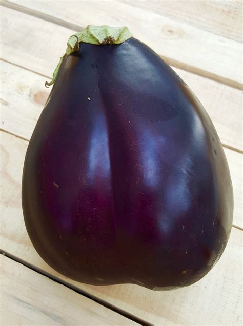 An Eggplant Sitting On Top Of A Wooden Table