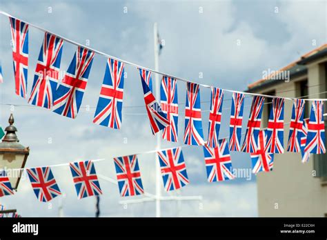 Union Jack Bunting Fluttering Against A Blue Sky On A Summers Day