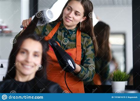 Hairdresser Put Hair To Client And Hold Comb And Hairdryer Stock Image