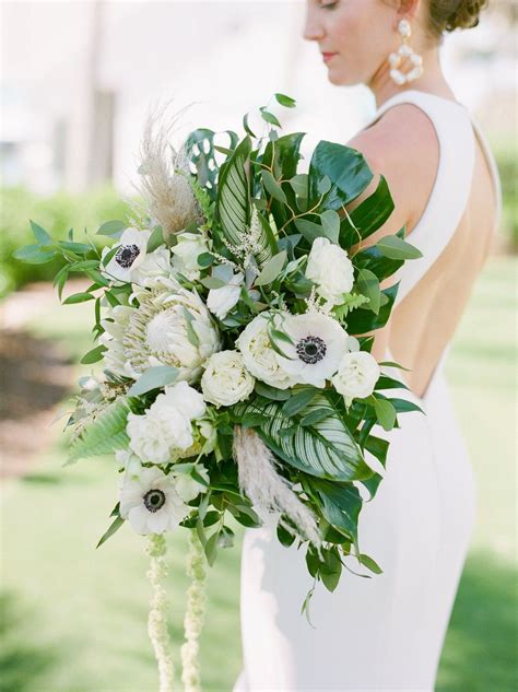 This tropical bouquet is totally unique. Tropical Chic Florida Wedding with a Massive Palm Leaf ...