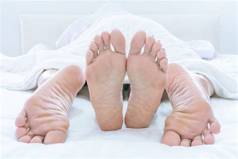 premium photo couples feet sticking out from under duvet or blanket make love at home on bedroom