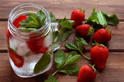Fresh Strawberry Lemonade With Ice And Mint In Jar On The Wooden Table