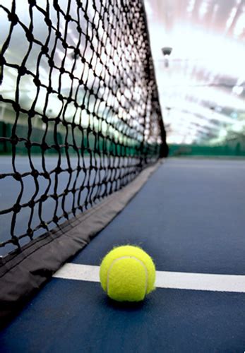 It is a firm rectangular surface with a low net stretched across the centre. Centre Sportif Tennis 13 Fitness - PRO Business Photos