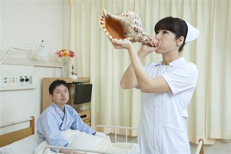 A Japanese Nurse Blowing A Horn Rwtfstockphotos