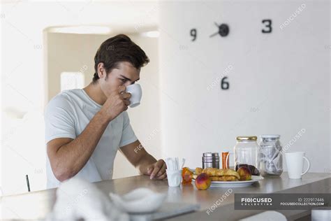 Close Up Of Young Man Drinking Coffee At Home — Warm Drink Lifestyle