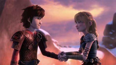 hiccup and astrid s moment of holding hands before they kiss from dreamworks dragons race to the