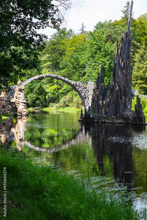 Rakotzbrucke Bridge In Germany Reflecting In The Water Stock Photo