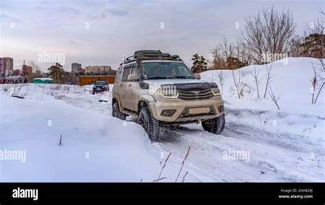 Russian Uaz Patriot Off Road Vehicles White And Dark Are Driving Fast