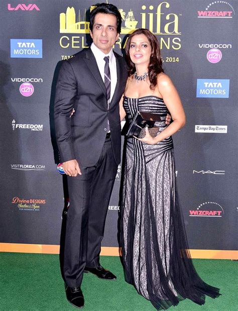 Perhaps this is the reason why they do not have to take anything special from lime light. Sonu Sood with wife Sonali on green carpet at #IIFA Awards ...