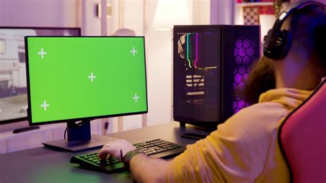 Playing Video Games On A Powerful Pc With Green Screen Display In A