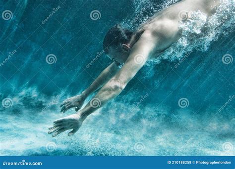 Side View Of Middle Aged Man Swimming Underwater Stock Photo Image Of