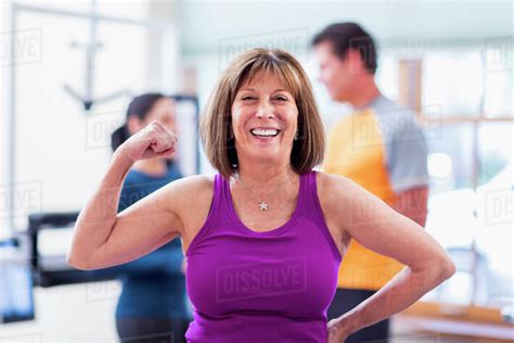 Caucasian Woman Flexing Her Muscles In Gym Stock Photo Dissolve