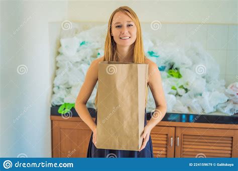 Woman Holding Paper Bag Amid A Pile Of Plastic Bags Zero Waste Concept Stock Image Image Of
