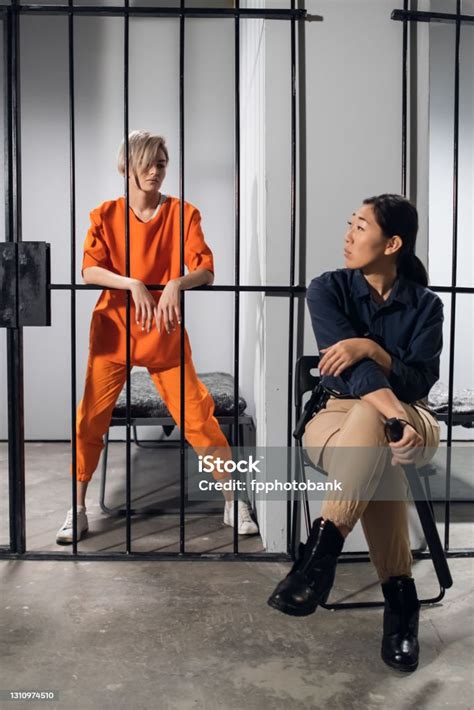 A Young Criminal And Her Female Guard Pose For A Photo In Prison Stock