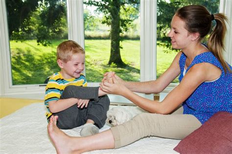 Girl Tickling Childs Foot Stock Photo Image 58175293