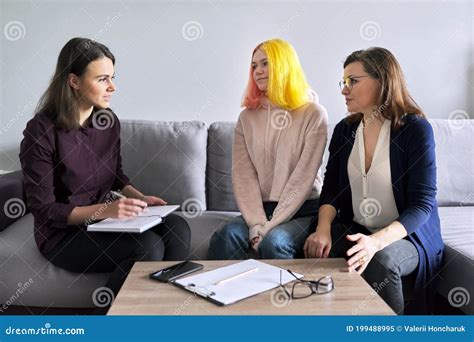 social worker psychologist at meeting with mature woman and her teenage daughter stock image