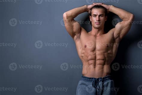 Handsome And Muscular Man Posing In Studio Stock Photo At Vecteezy