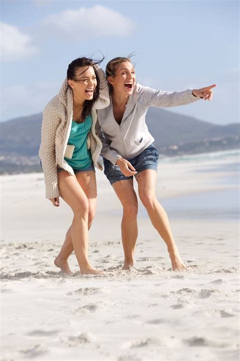 Two Friends Laughing And Enjoying Life At The Beach Stock Image Image