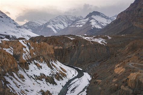 Aerial View Of Spiti River Flowing Across The Snow Capped Mountains