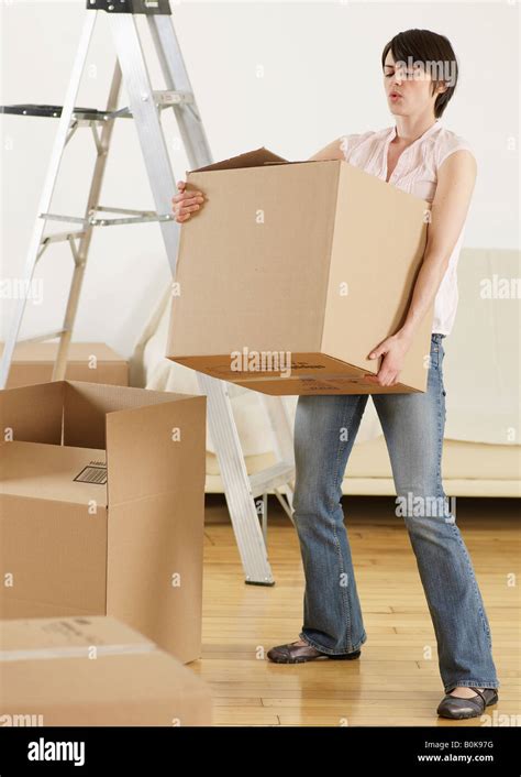 Young Woman Carrying Heavy Cardboard Box Stock Photo Alamy