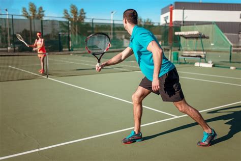 Premium Photo Couple Playing Tennis On Outdoor Court