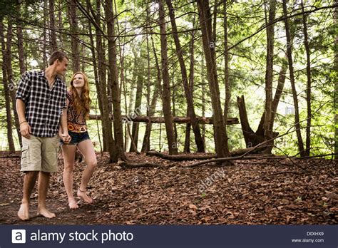 Couple Walking Through Forest Stock Photo Alamy