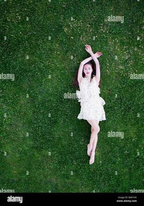 Beautiful Young Woman Lying On Grass Stock Photo Alamy