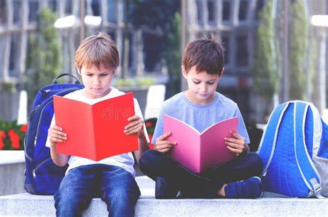 Children Reading Books Outdoors Stock Image Image Of Holding City