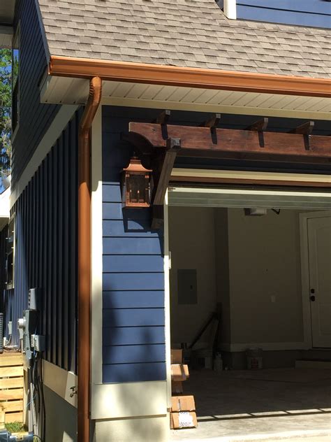 Getting the lowdown on downpipes. Copper Penny gutters look like dazzling jewelry against ...