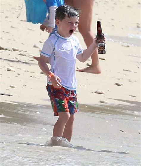 wayne rooney s five year old son kai holds bottle of lager on idyllic barbados beach irish