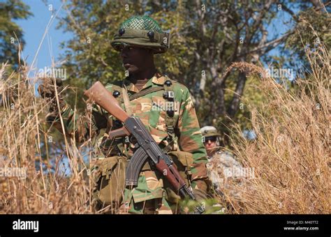 A Soldier With The Zambian Defense Force Signals To A United States