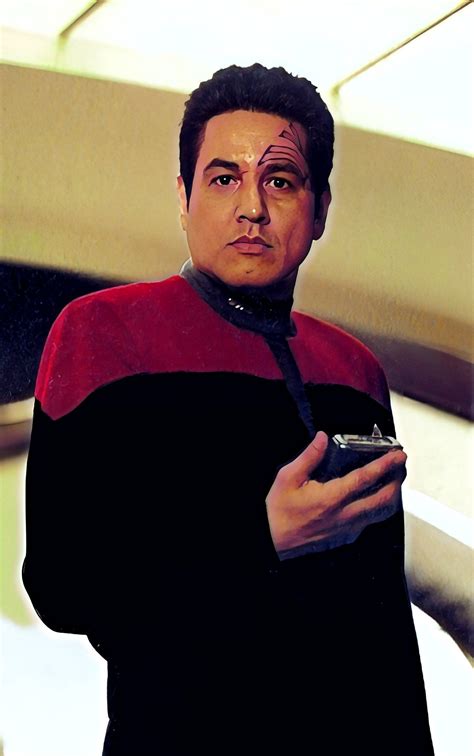 A Man In A Star Trek Outfit Holding A Cell Phone