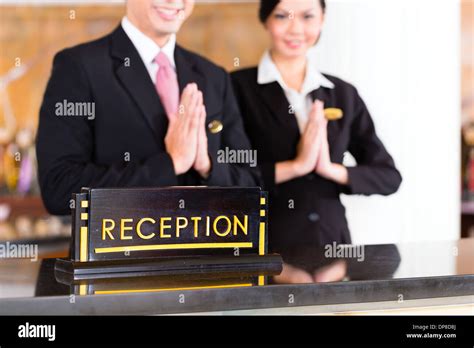 Chinese Asian Reception Team At Luxury Hotel Front Desk Welcoming