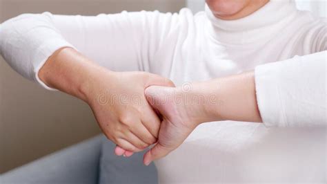 Close Up Of Young Woman Hands Doing Hand Massage By Herself For Soothing And Relaxing Stock