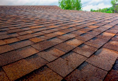 A Close Up View Of A Brick Roof With Trees In The Background
