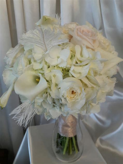 Classic white bouquet with a whimsical addition of white feather. | White bouquet, White 