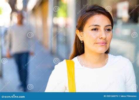 smiling confident girl standing outdoors with man in background stock image image of latina