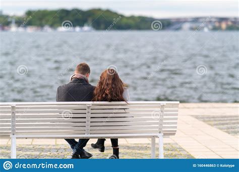 Couple Sitting On A Bench Overlooking Water Stock Image Image Of Couple Rendezvous 160446863