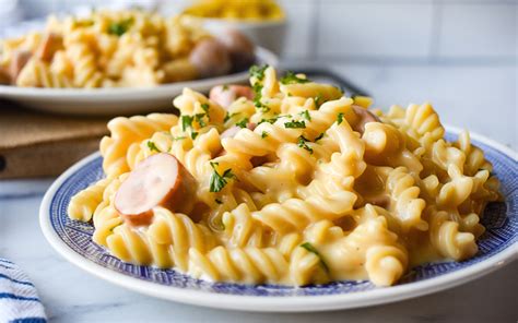 It's a cheesy pasta dish with kielbasa sausage and garnished with chopped scallions. Cheesy Smoked Sausage Pasta | 30 Minute Meal | EatWheat.org