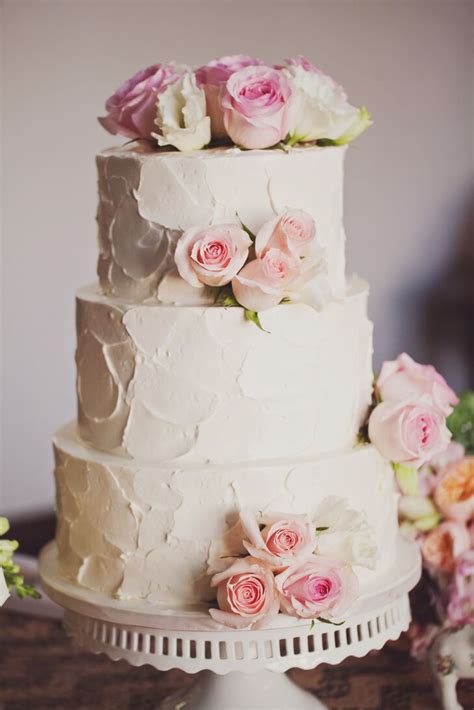 Three Tiered Rustic Wedding Cake Topped With Blush Flowers
