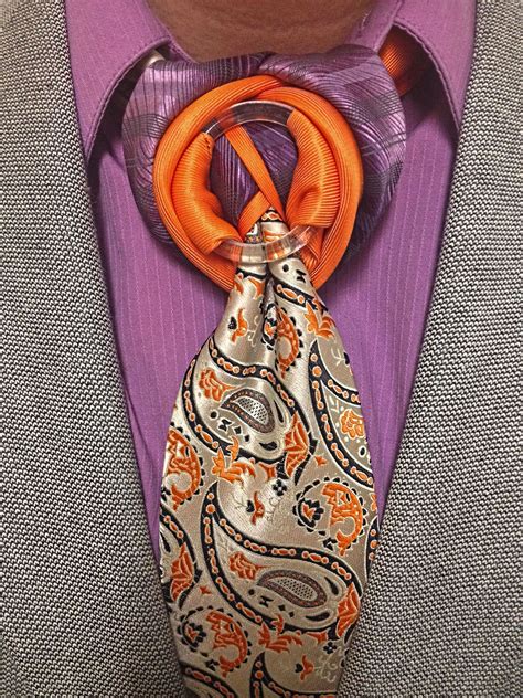 Here A Contrast Tie A Ring And A Mostly Solid Colored Necktie Are