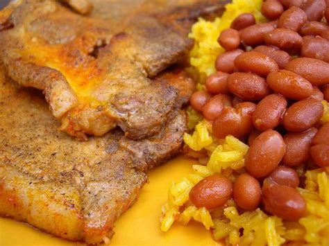 1lb kan kan puerto rican style pork chop marinated with our garlic rub & fried to tender perfection including crunchy pork rind. pork chops, yellow rice and beans | Latin Heritage ...