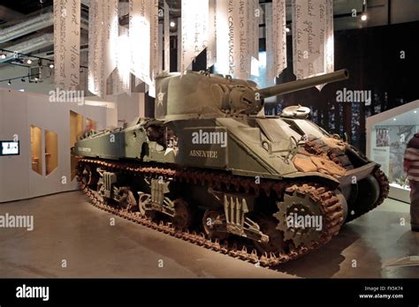 A Badly Damaged American M4 Sherman Tank In The Bastogne War Museum